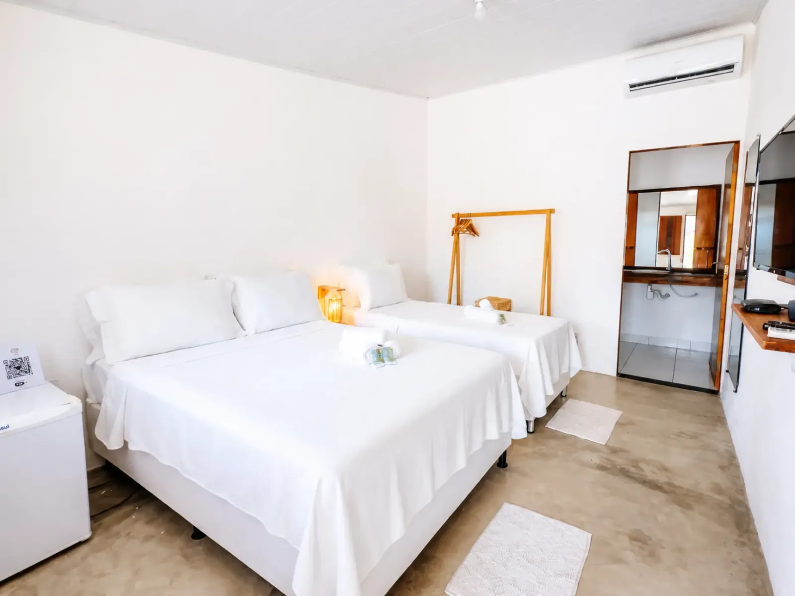 Triple room with a full bed and a separate twin bed beside the private bathroom